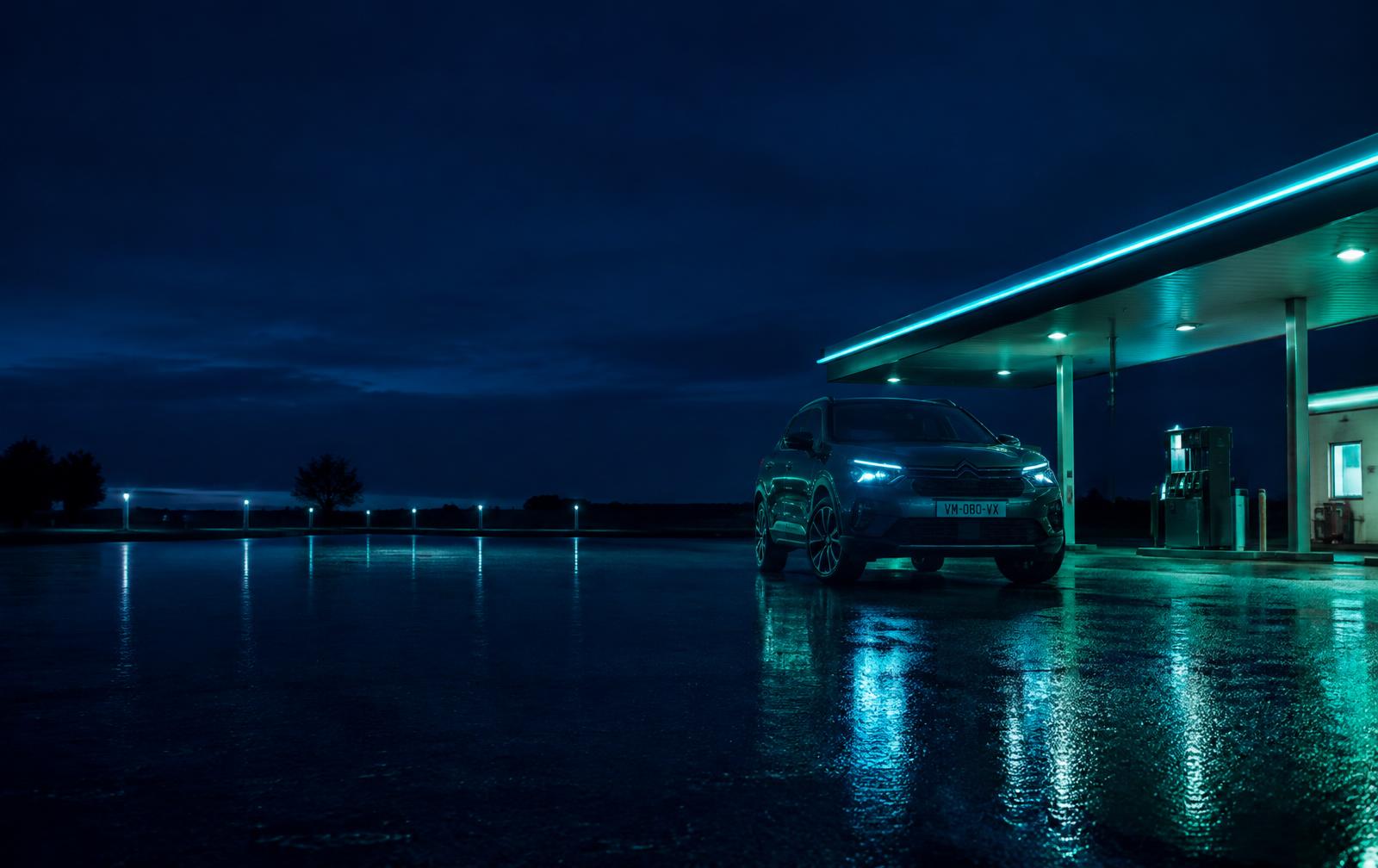SUV at a fuel station at night